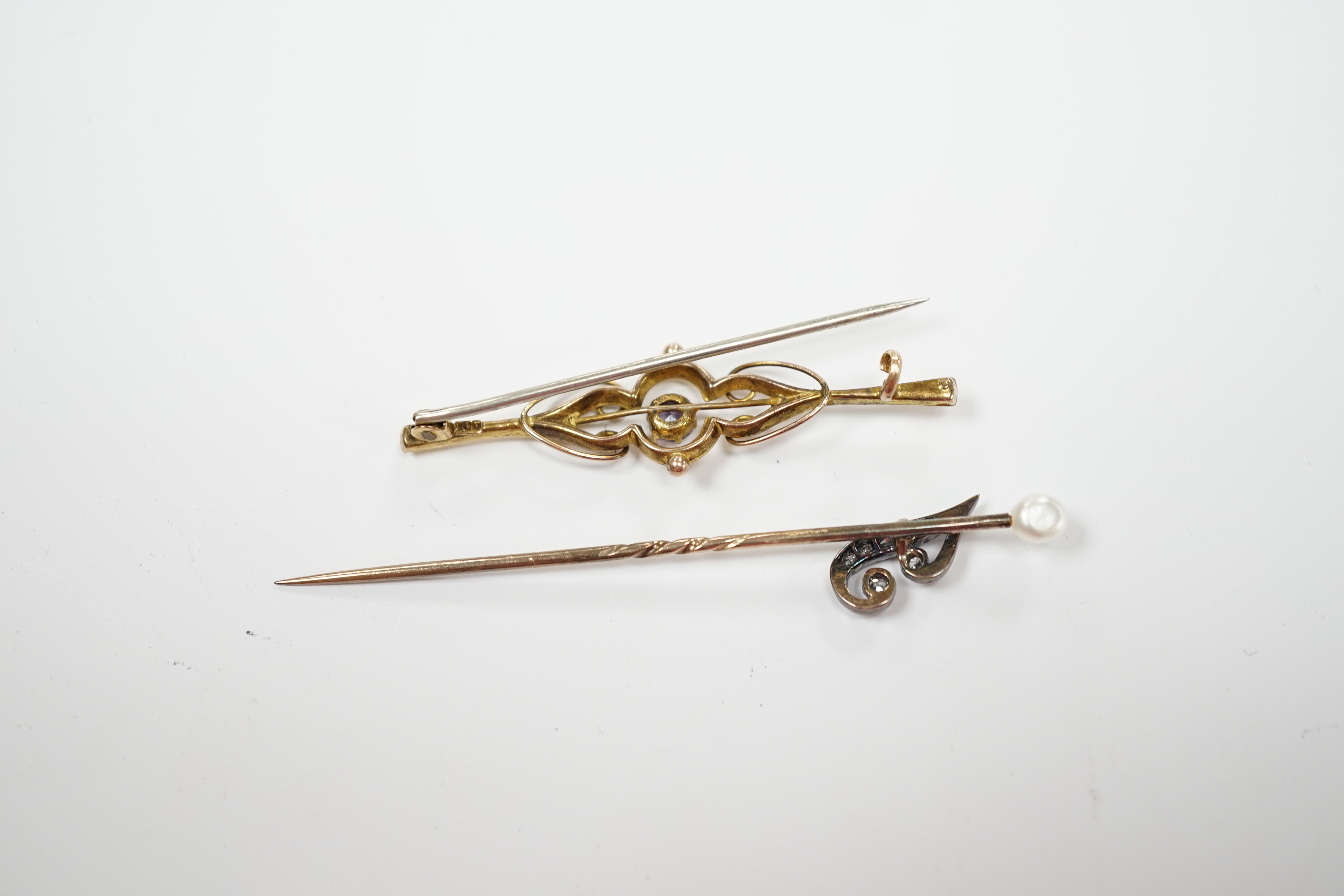 An early 20th century diamond chip and seed pearl set initial stick pin, 65mm and a 9ct and gem set brooch.